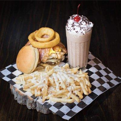 Cheeseburger with grilled chicken, bacon, onion ring with cheese fries and a chocolate shake