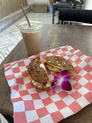 Don Ho on Everything bagel breakfast sandwich with bacon, egg, American cheese and schmear. Brown sugar and cinnamon iced latte.