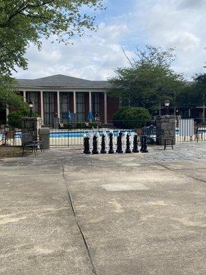 Courtyard with pool and large chess pieces and checkers