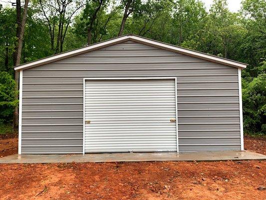 24x36 building installed with dented door by Universal Metal Buildings