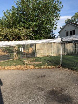 Outdoor area for the dogs to roam. Bigger than it looks, a fenced in path wraps around and opens up to an even bigger space in the back.