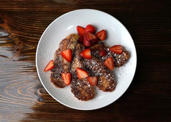 Pain Perdu - french bread dipped in our custard mix and grilled.  Topped with powdered sugar and sliced strawberries.