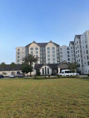 Front Entrance of hotel from grass field.