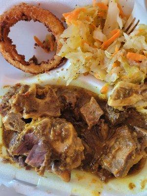 Curry goat, steamed cabbage and onion rings