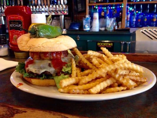 The "Diablo Fuego" burger w/pepper jack cheese, onion ring, bacon, lettuce, tomato and topped with a roasted jalapeño.