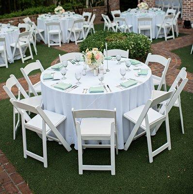 Resin Folding Wedding Chairs white and round tables set up