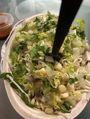 Chicken bowl with white rice, corn, cheese, romaine, and sour cream