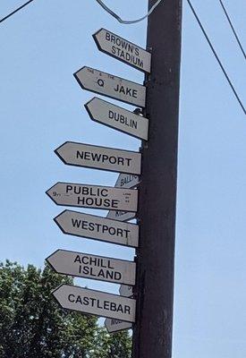 Signposts to communities all over Ireland and  Cleveland stadium for the Browns and Indians in the back parking lot of the pub