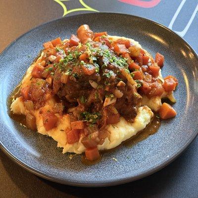 Lamb Osso Buco on garlic mashed potatoes with gemolata