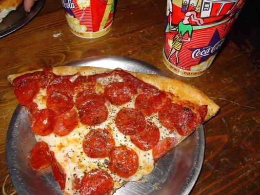 Best pizza in the world, and I've been around the world! That's 1 slice next to 2 big-ass cokes! Only thing beet would be 2 slices!