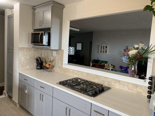 Opening in wall added; new cabinets, countertops, floors and backsplash