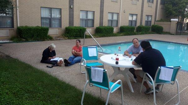 Nice weather allows students to work at the pool.