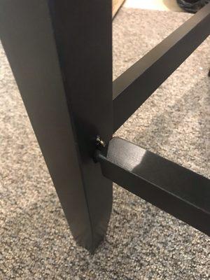 Screw sticking out, bar not lined up.