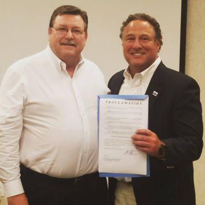 City of Athens Mayor Monte Montgomery presents the Uncle Fletch Festival Proclamation to Attorney Jeff Weinstein