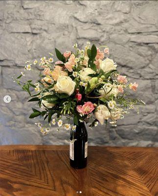 Wine bottle arrangement.
 Sweet peas, Camomile, rose hellebores & jasmine.
 Couple romance dinner, drink and enjoy your flowers.