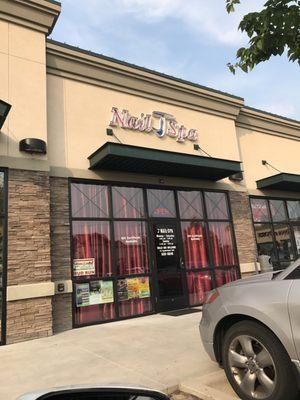 Doesn't look very inviting. I've never seen a salon w red curtains covering all the windows.