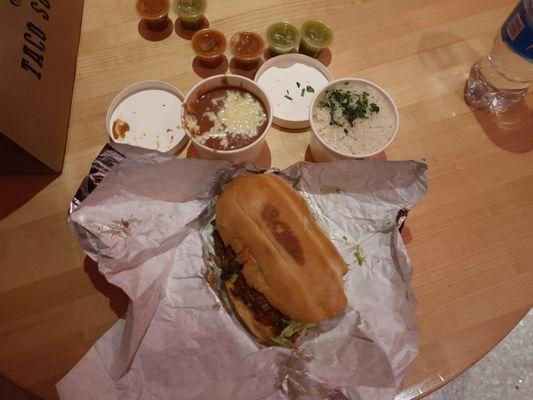 Grilled steak torta ($15) and sides of rice and beans ($4 each).