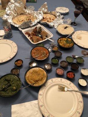 Our feast! Sauce tray, naan, Garlic Naan, chicken Saag, Chicken Tikka, Starter Platter, vegetable Curry, and Korma