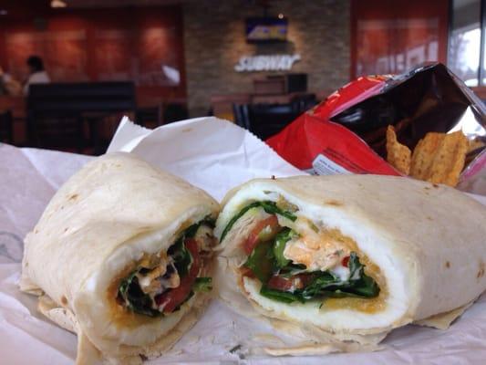 Egg white wrap and Garden Salsa Sun Chips with a metal Subway sign and fireplace in the background.