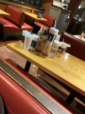 Dirty table w/ trash on the floor