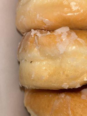 An ant or a spider is cooked on my donut. I called the store and they did not answer the phone to resolve my issue. This is unacceptable!