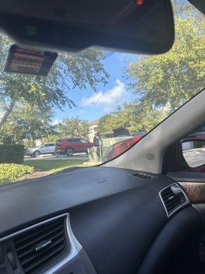 The maintenance guy blocking a resident parking spot and doing nothing but hanging out by his car.