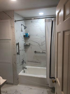 These Corian wall panels continue around the corner of the shower for a seamless and custom built look.