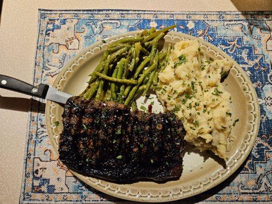 NY strip steak dinner with mashed potatoes and green beans