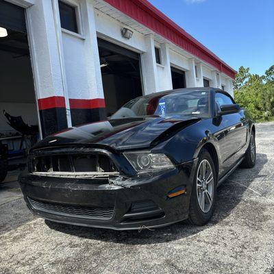 Pre collision repairs on a 16 Ford Mustang damaged front end