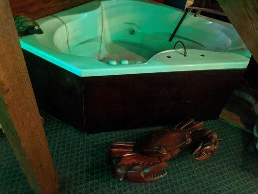 A strange hot tub with large plastic crabs around it