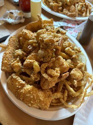 Haddock, clams, shrimp, scallops, onion rings and French fries.