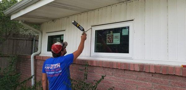 Spray foaming the new awning windows.