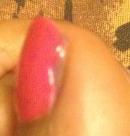 Side view of left big toe, nail unevenly painted.