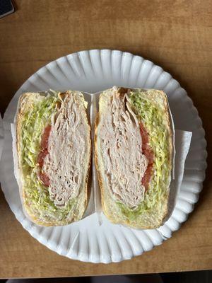 Turkey with lettuce and tomato on a roll