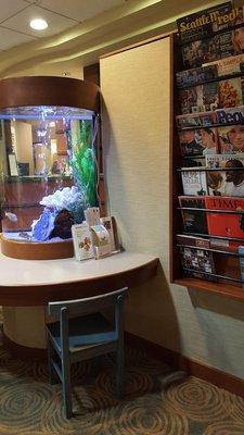 Waiting area with giant aquarium and one of two magazine stands (6/25/18)