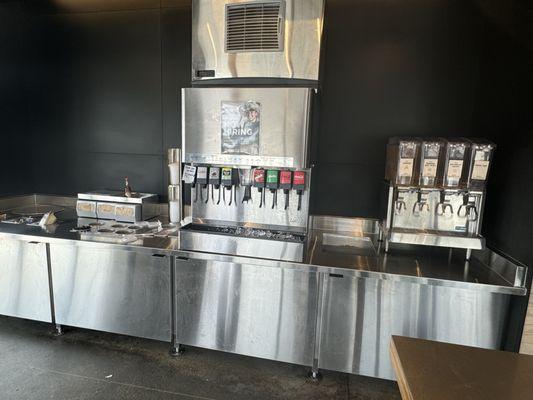 Empty tea bins. Filthy counter. Empty utensils. Garbage overflowing.