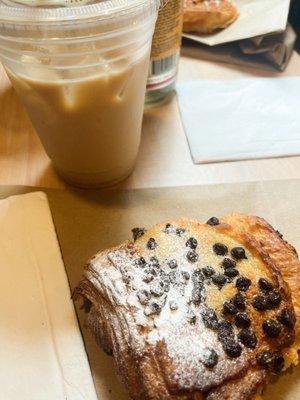 chocolate chip almond croissant with an iced chai latte