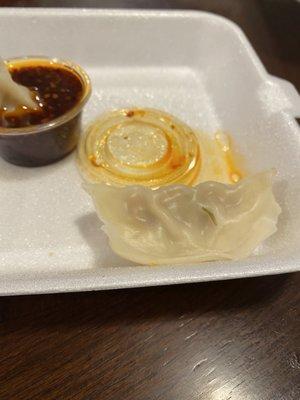 Steam dumpling with a dead larvae on it