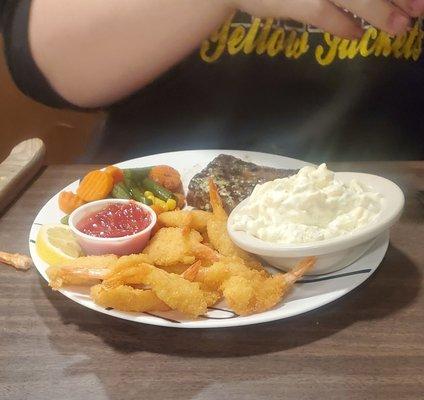 Well done steak, shrimp, mixed veggies and potato salad.