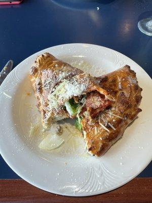 Calzone with pepperoni, sausage, green peppers, and onion.