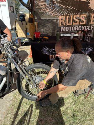 Daniel Standing Bear Huerta repairing my flat front tire @BornFree15. Thank goodness for this man!