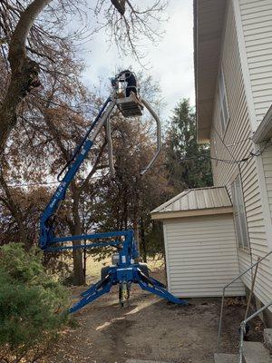 Using machinery to reach the top.