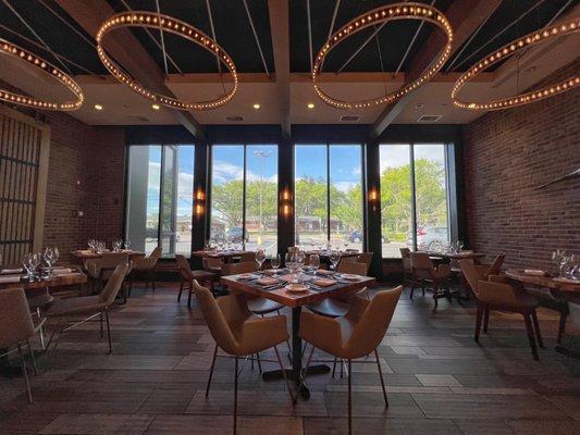 Interior view of a Restaurant with Chandelier like ceiling lights and ceiling to floor windows