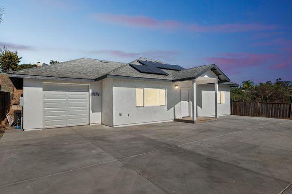 Sunset glow on a newly completed, solar-powered 2-bedroom home--modern design meets sustainable living.