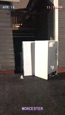 Appliances left in the rain at parking lot of property