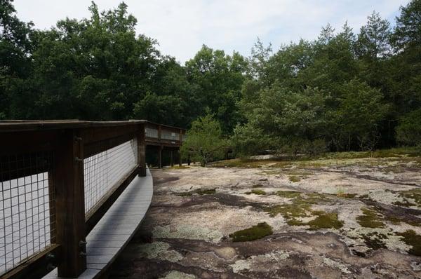 Boardwalk on south end of hiking trail that spans a rock outcrop.