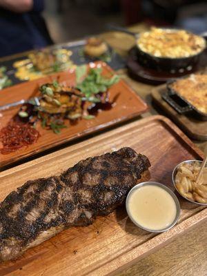 Top right, clockwise: Mac and cheese, au gratin potatoes, New York strip steak, tiger shrimp, crab cakes