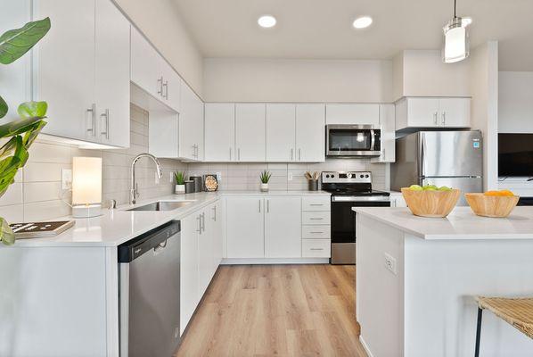 Brand new kitchen featuring stunning quartz countertops and stainless steel appliances.