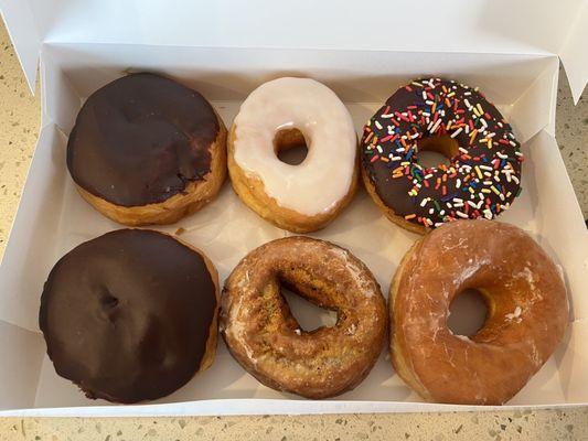 Boston Cream, Vanilla Frosted, Chocolate Frosted with Sprinkles, Pumpkin, and Glazed Donuts