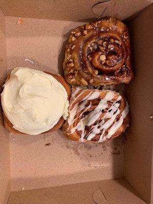 CinnAmon roll with cream cheese frosting, iced walnut raisin roll and sticky bun